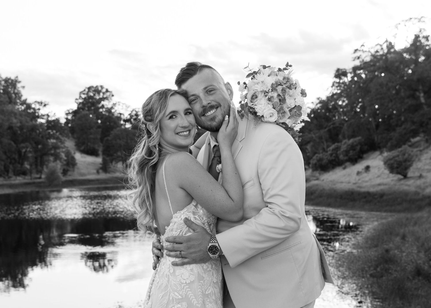 Romantic outdoor wedding photos captured near a serene lake.
