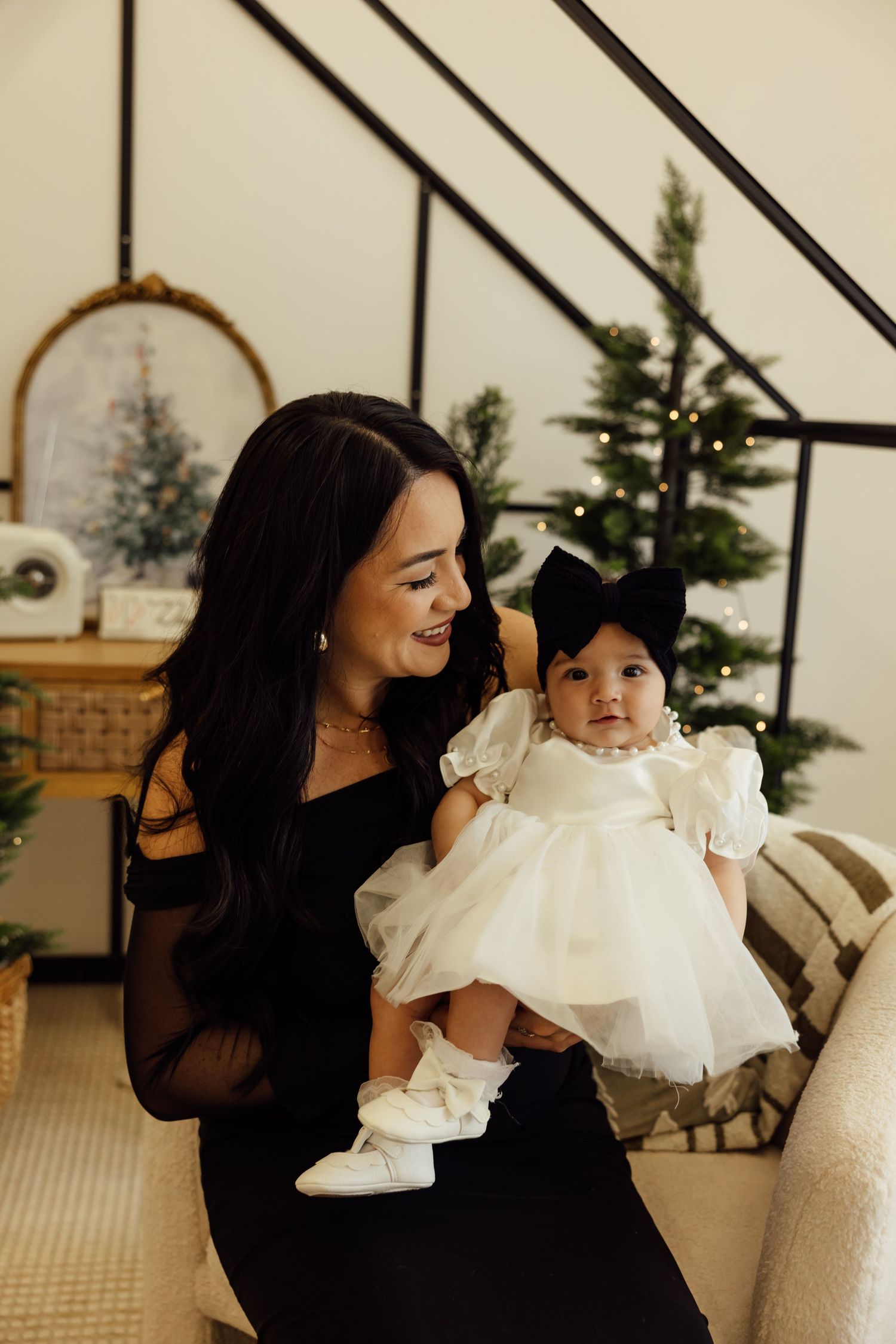 A series of tender moments captured between two people in black and white outfits against a neutral background.