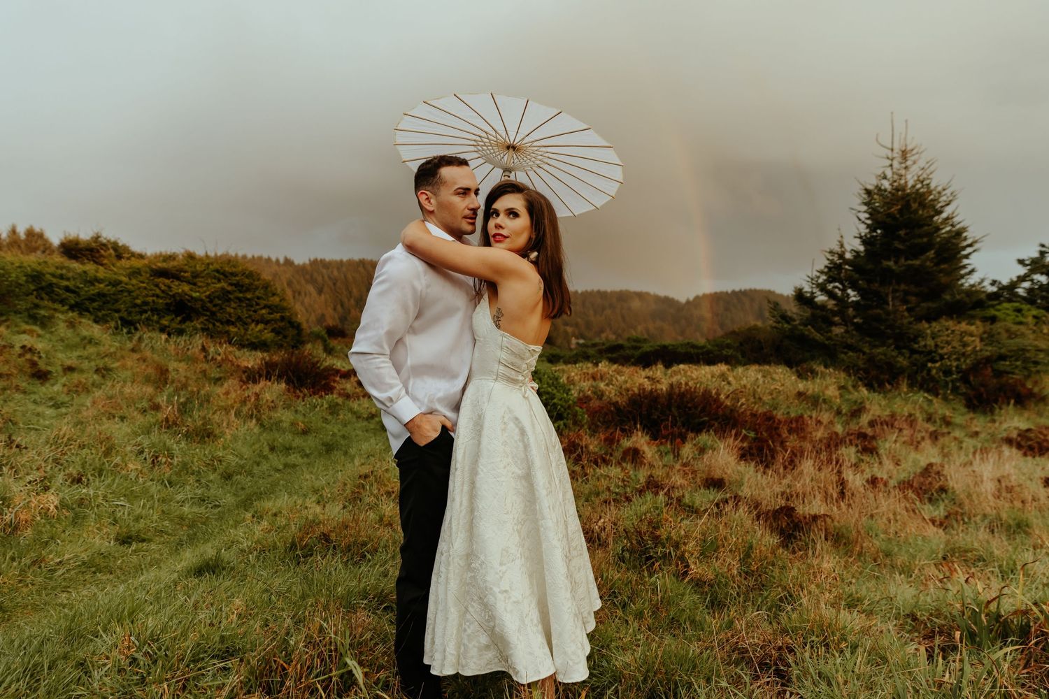 Intimate mountain wedding portraits with dramatic landscape views at sunset.