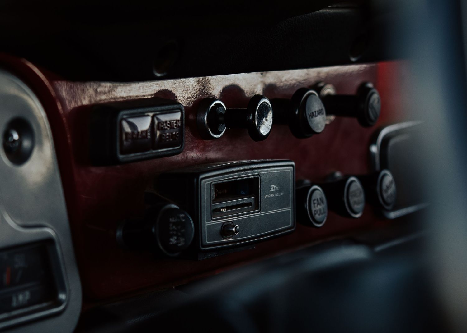 Interior dashboard view of classic Toyota Land Cruiser showing vintage controls and gauges.