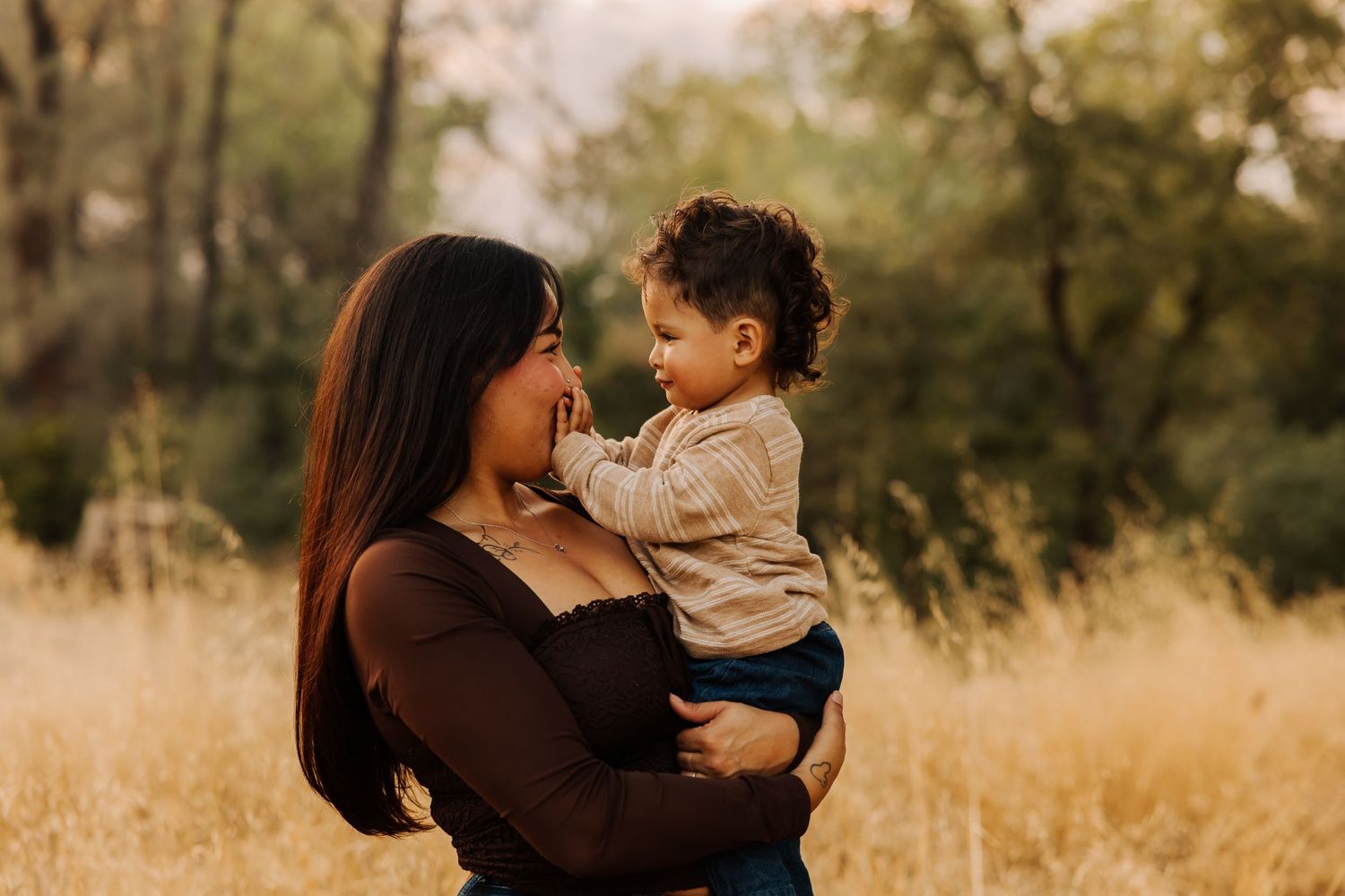 Candid family moments captured in warm golden light among autumn foliage.