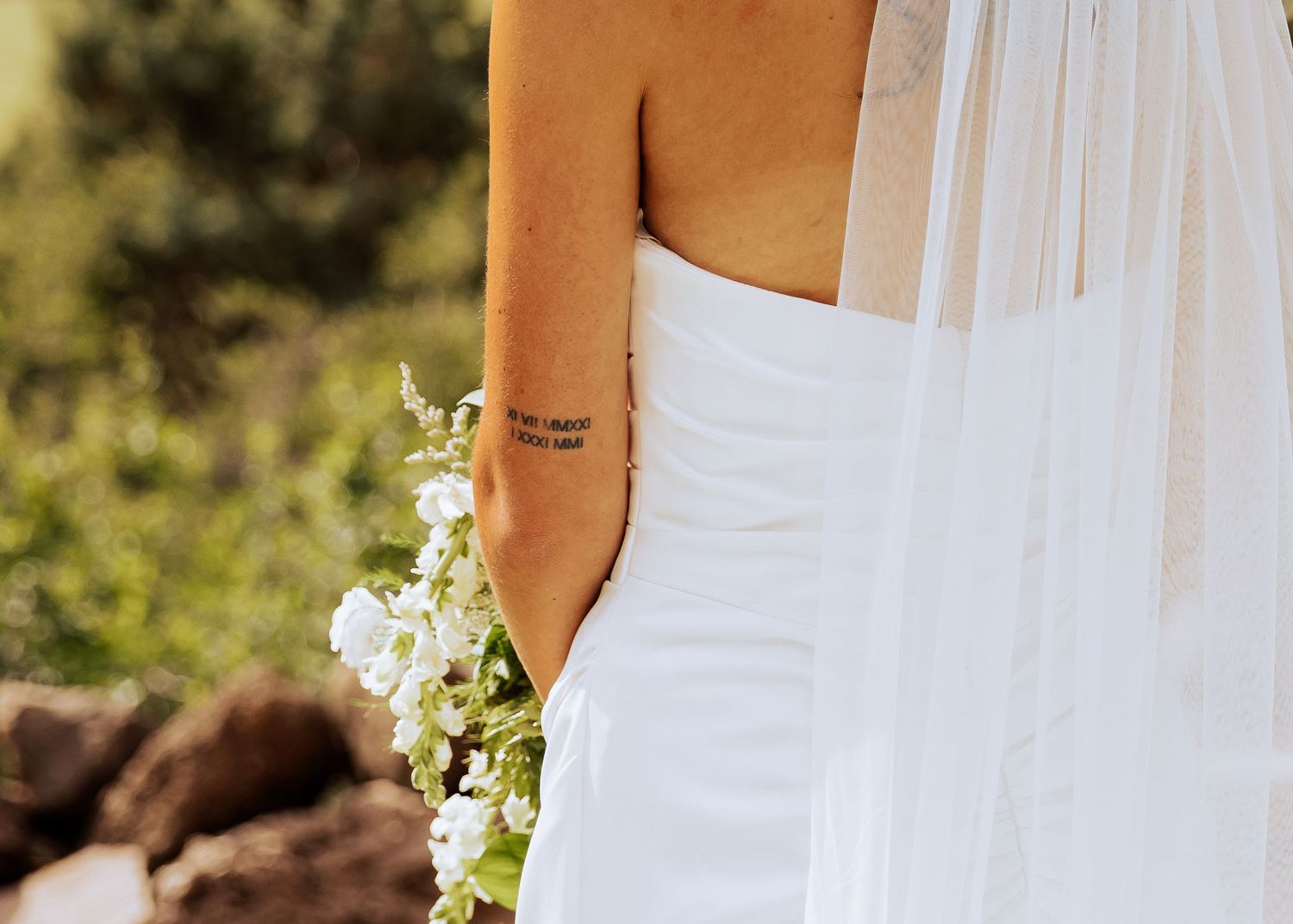 Close-up details of a white flowing wedding dress with delicate fabric.