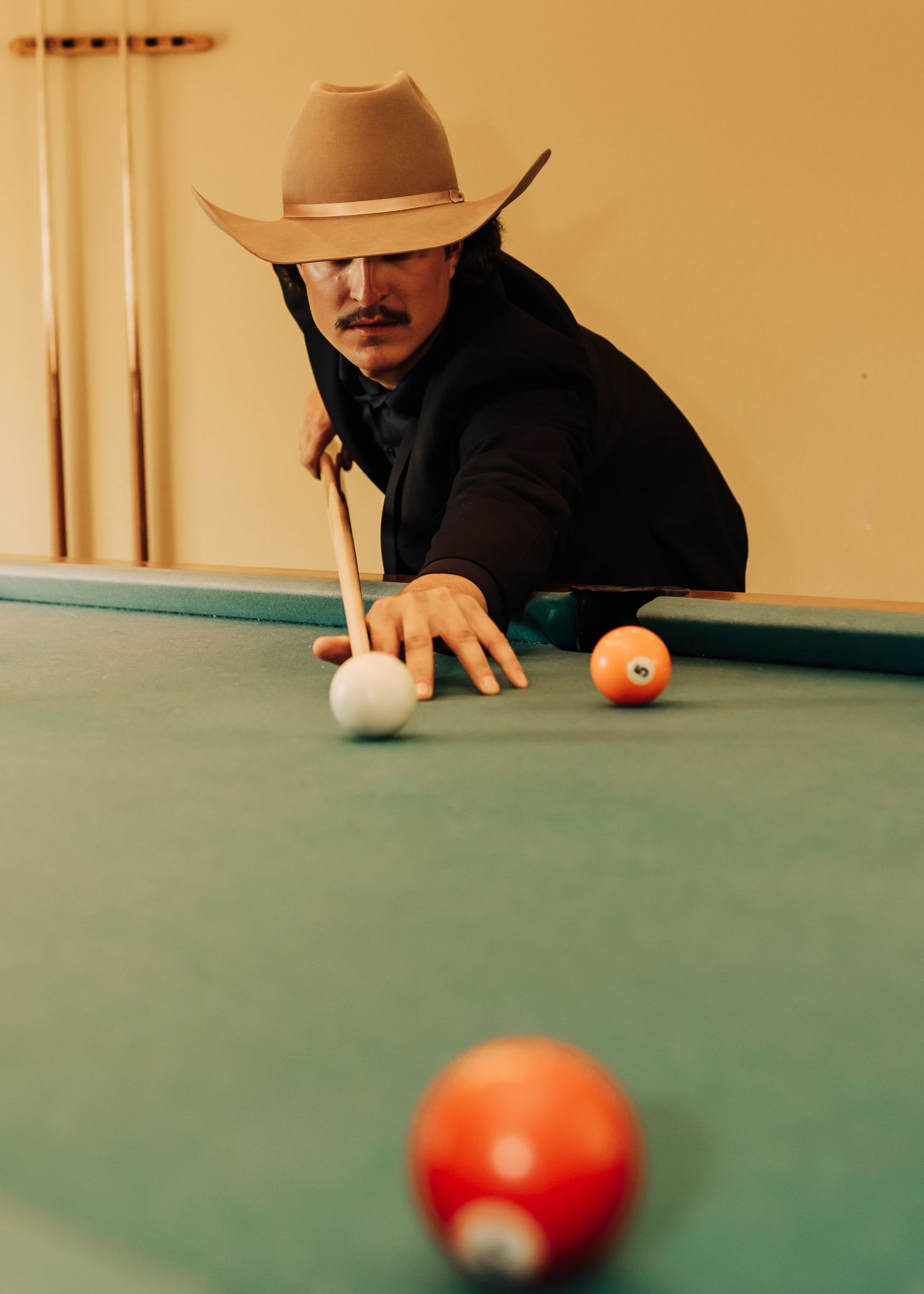 Sequential shots of a pool player making a shot on a green felt table.