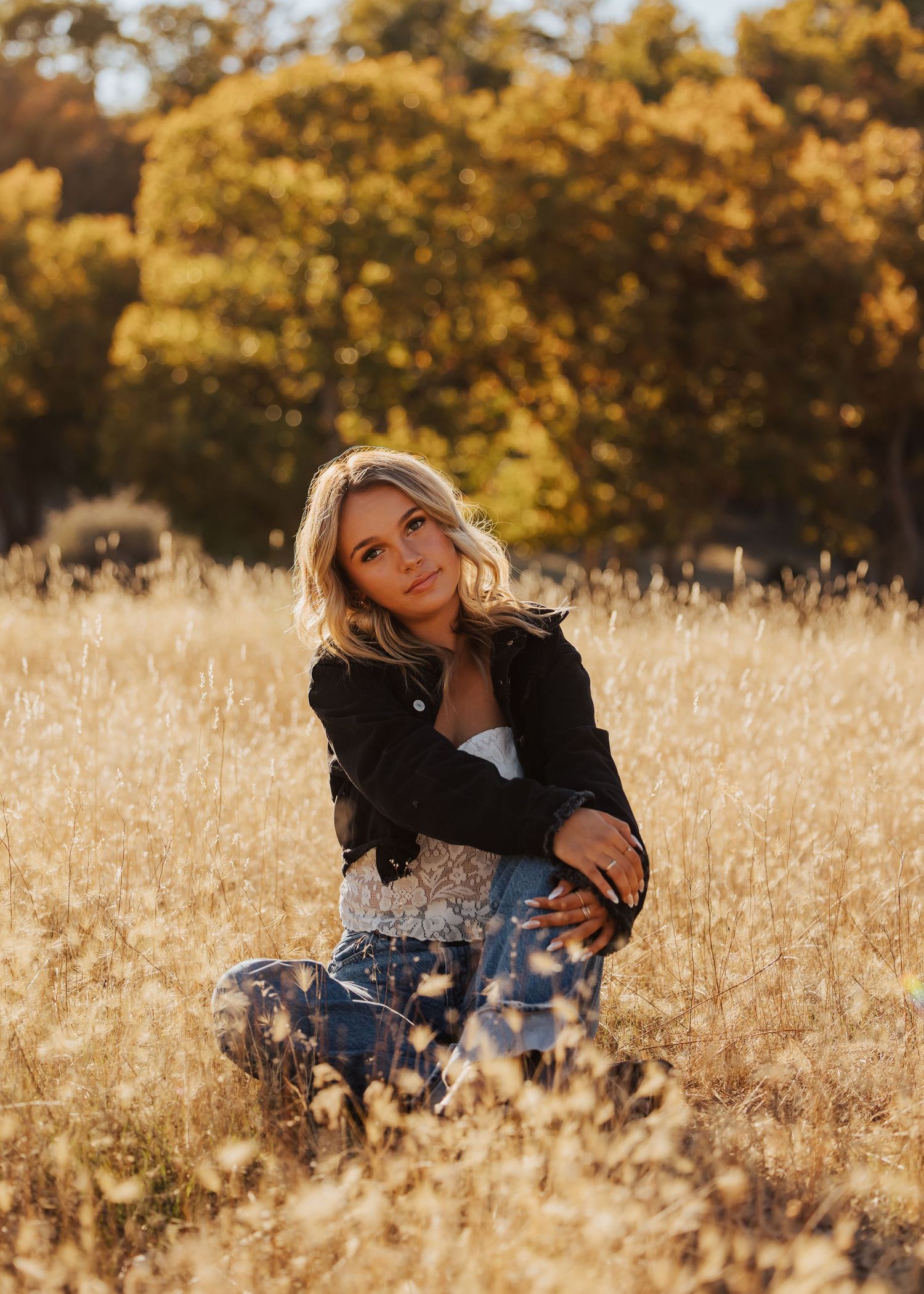 Artistic portrait series in a golden wheat field during sunset with soft natural lighting.
