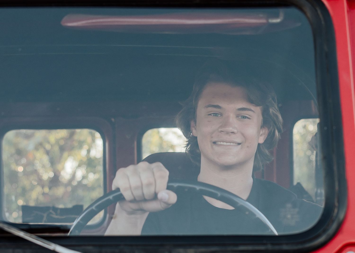 View through windshield of classic red Toyota Land Cruiser.