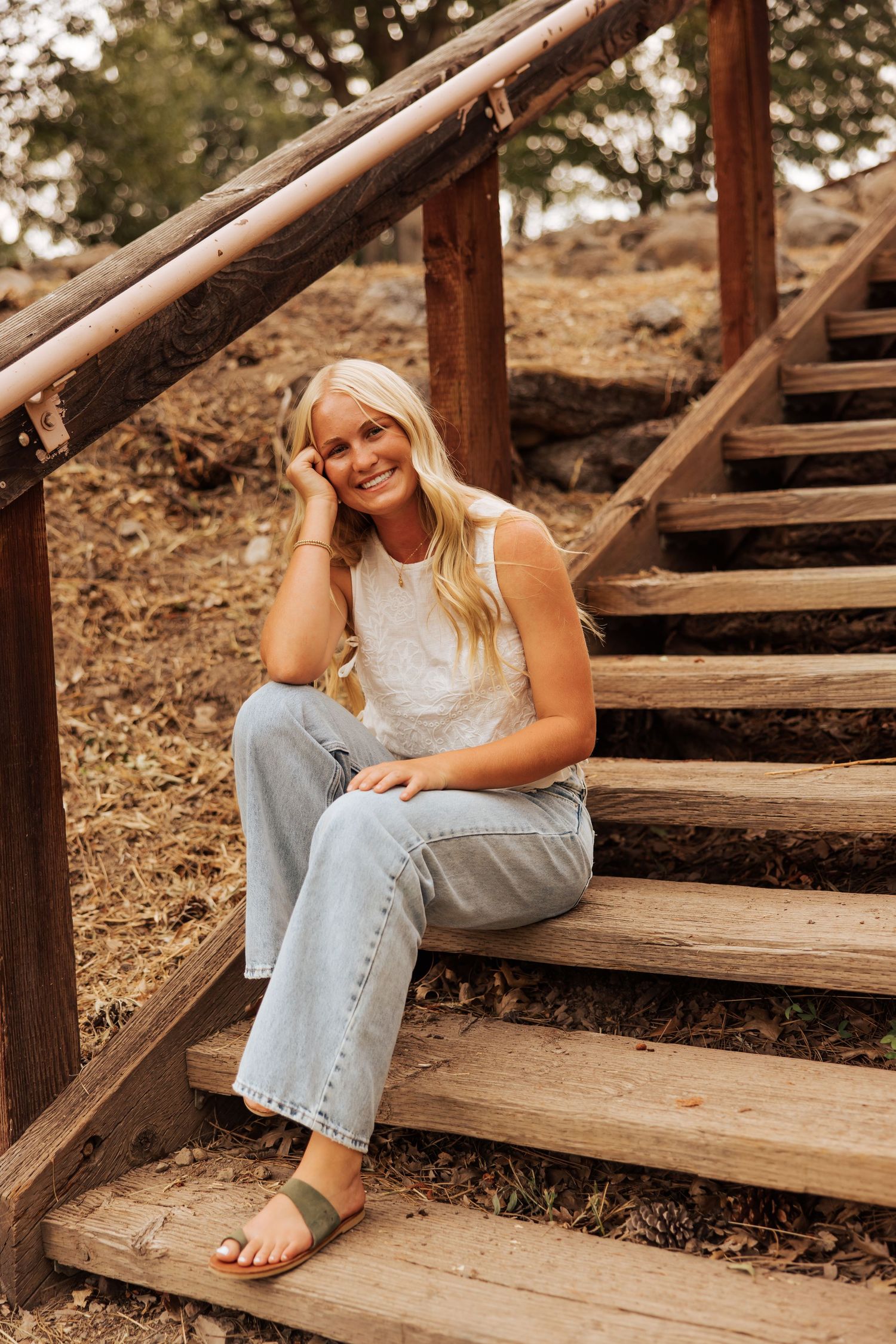 Relaxed poses on wooden steps during golden hour photography session.