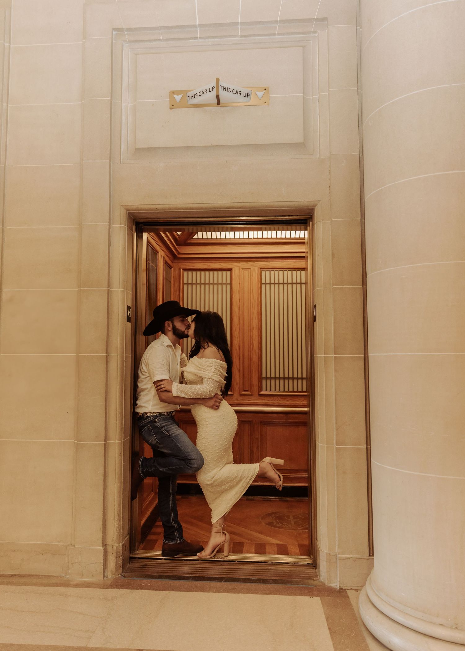 A panoramic view of a person sitting in an ornate hallway with white stone walls and wooden doors.