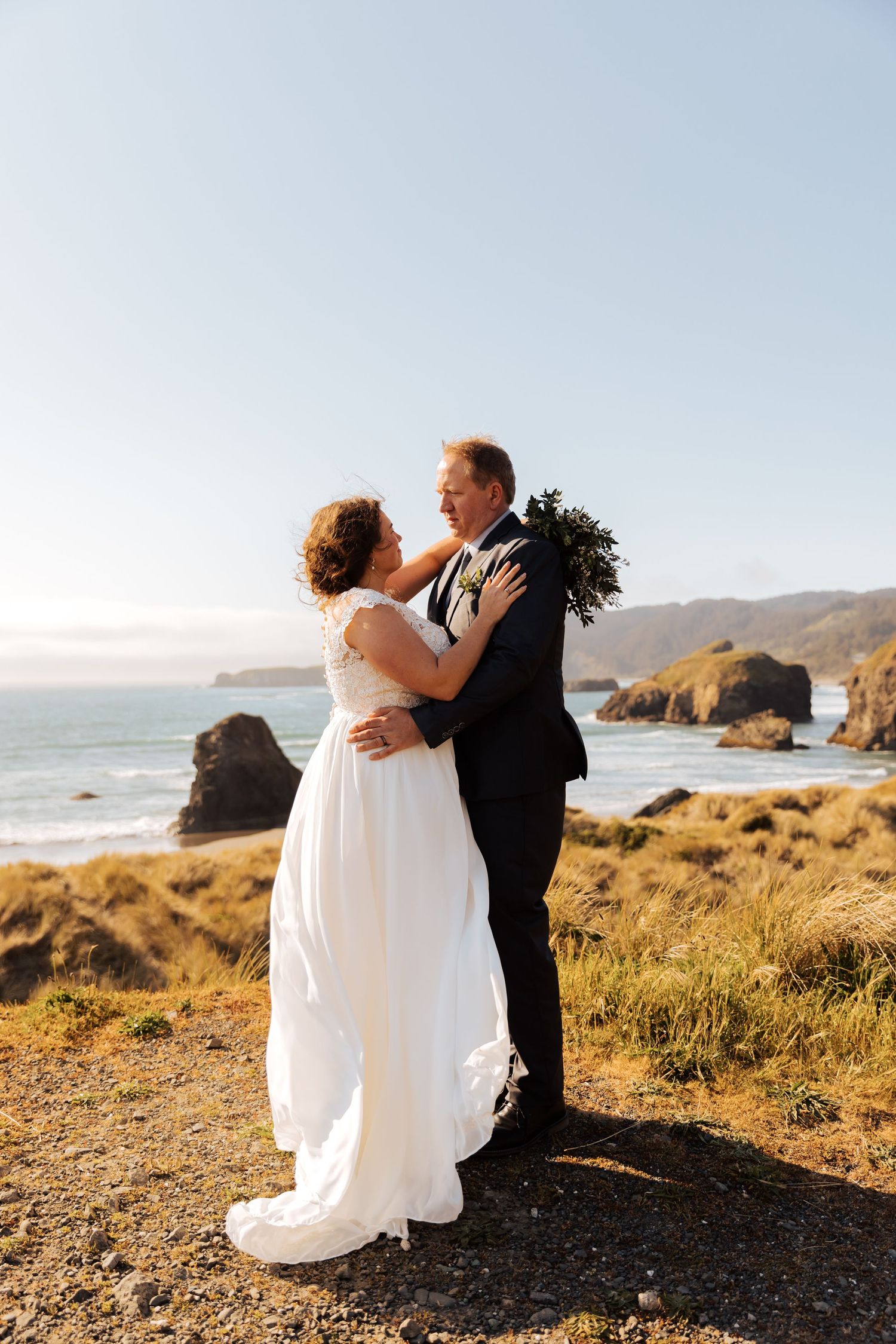A joyful wedding moment captured against the backdrop of a stunning coastal landscape.