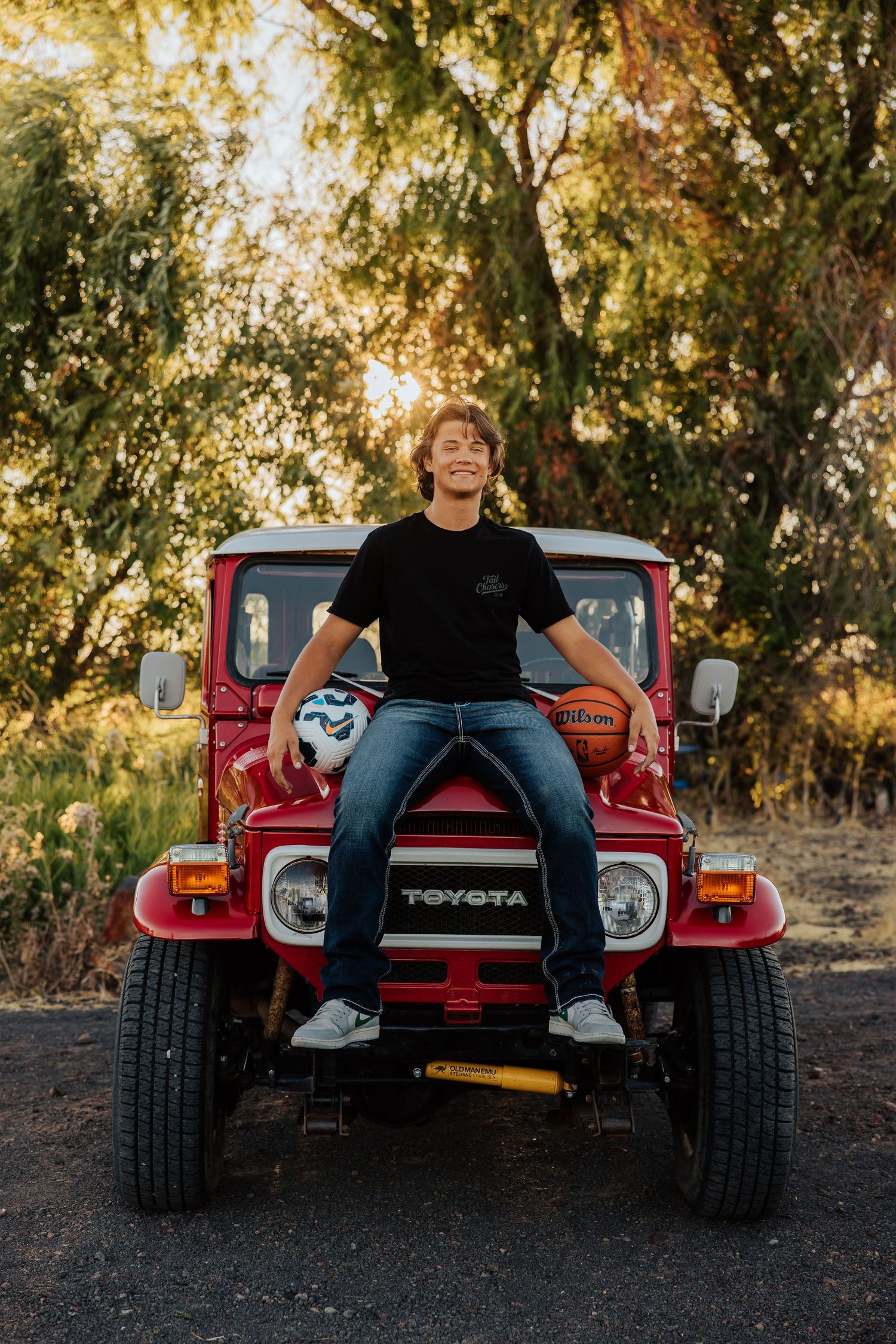 A red vintage Toyota vehicle photographed from different angles against a natural outdoor backdrop at sunset.