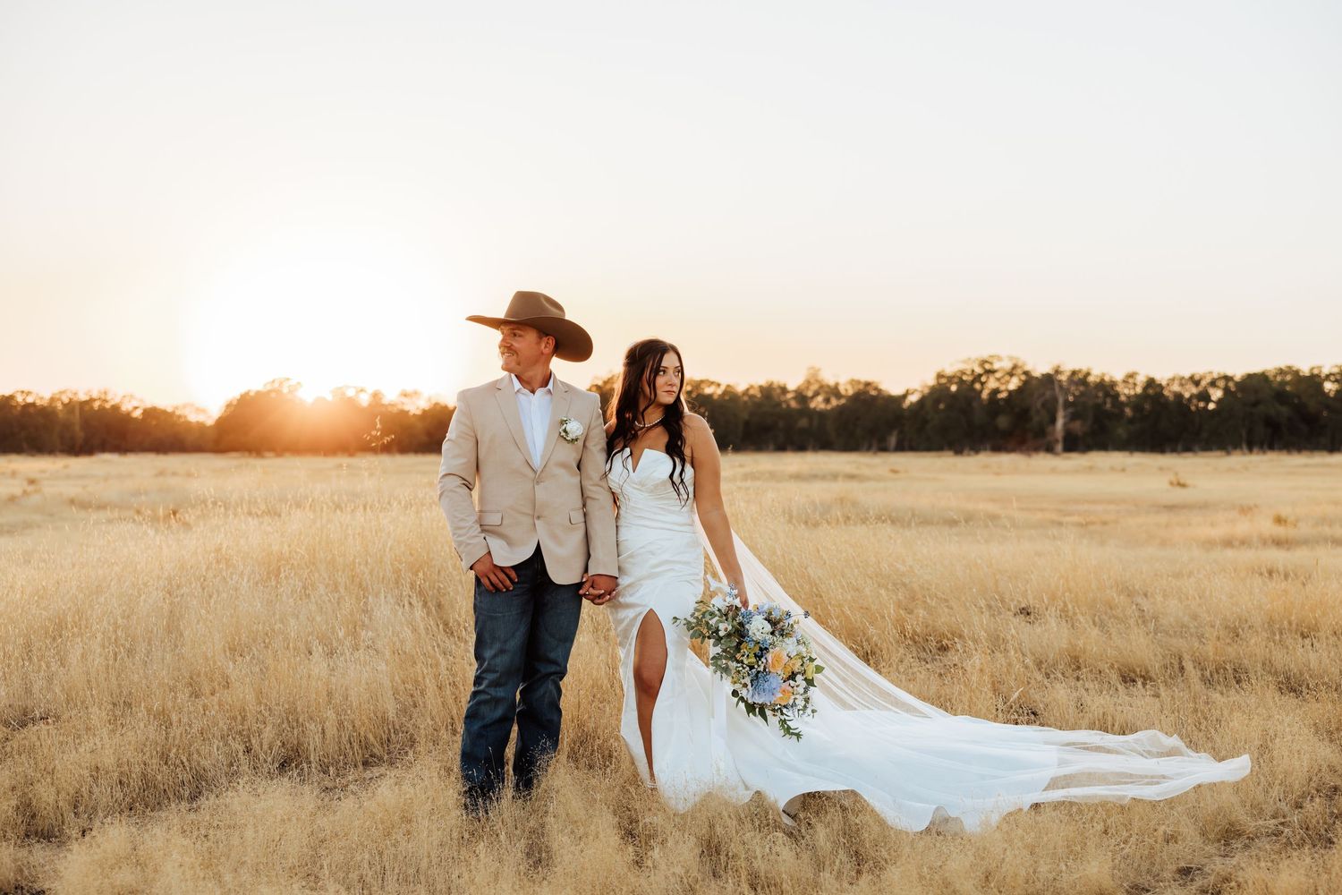 Romantic sunset photoshoot in a golden wheat field with flowing white dress.