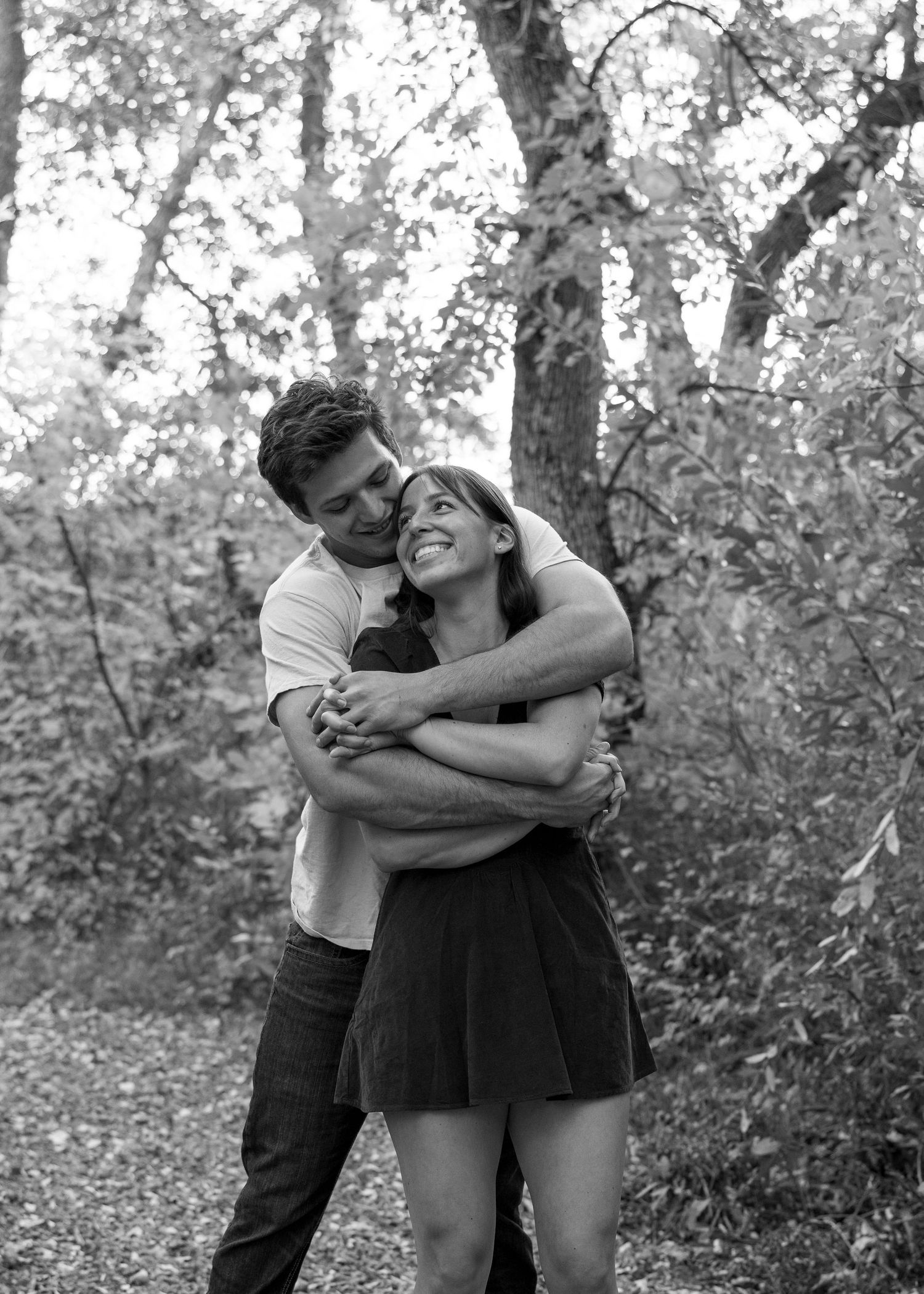 Black and white photo series of a couple embracing and laughing together.