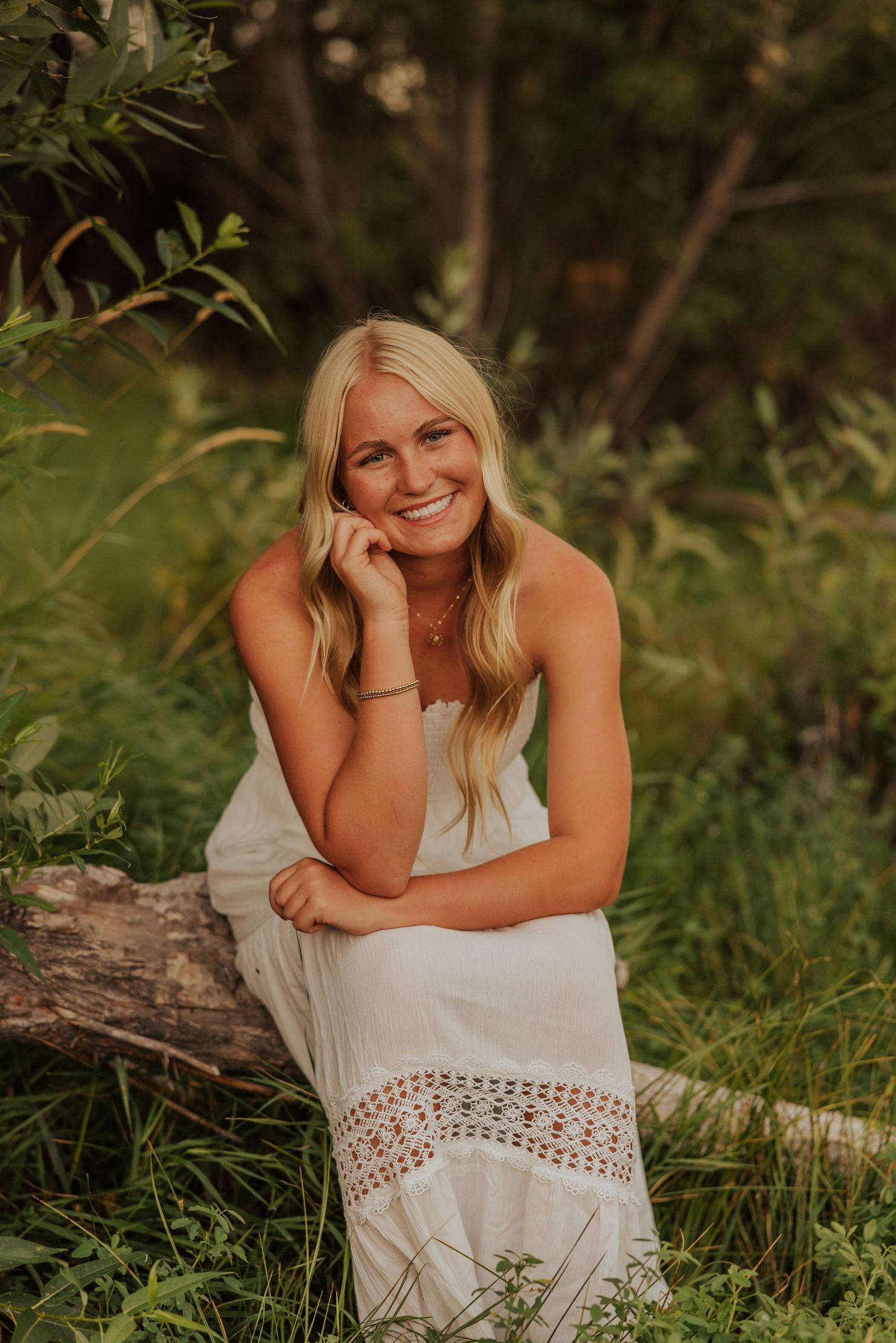 Natural outdoor portrait session in a lush green setting during golden hour.