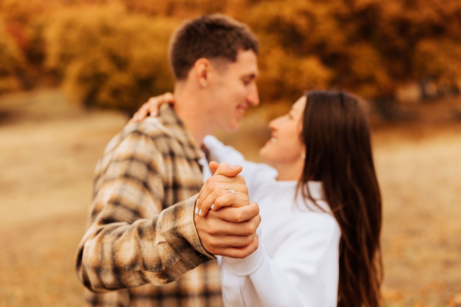 Close-up shots of tender moments during an autumn engagement session.