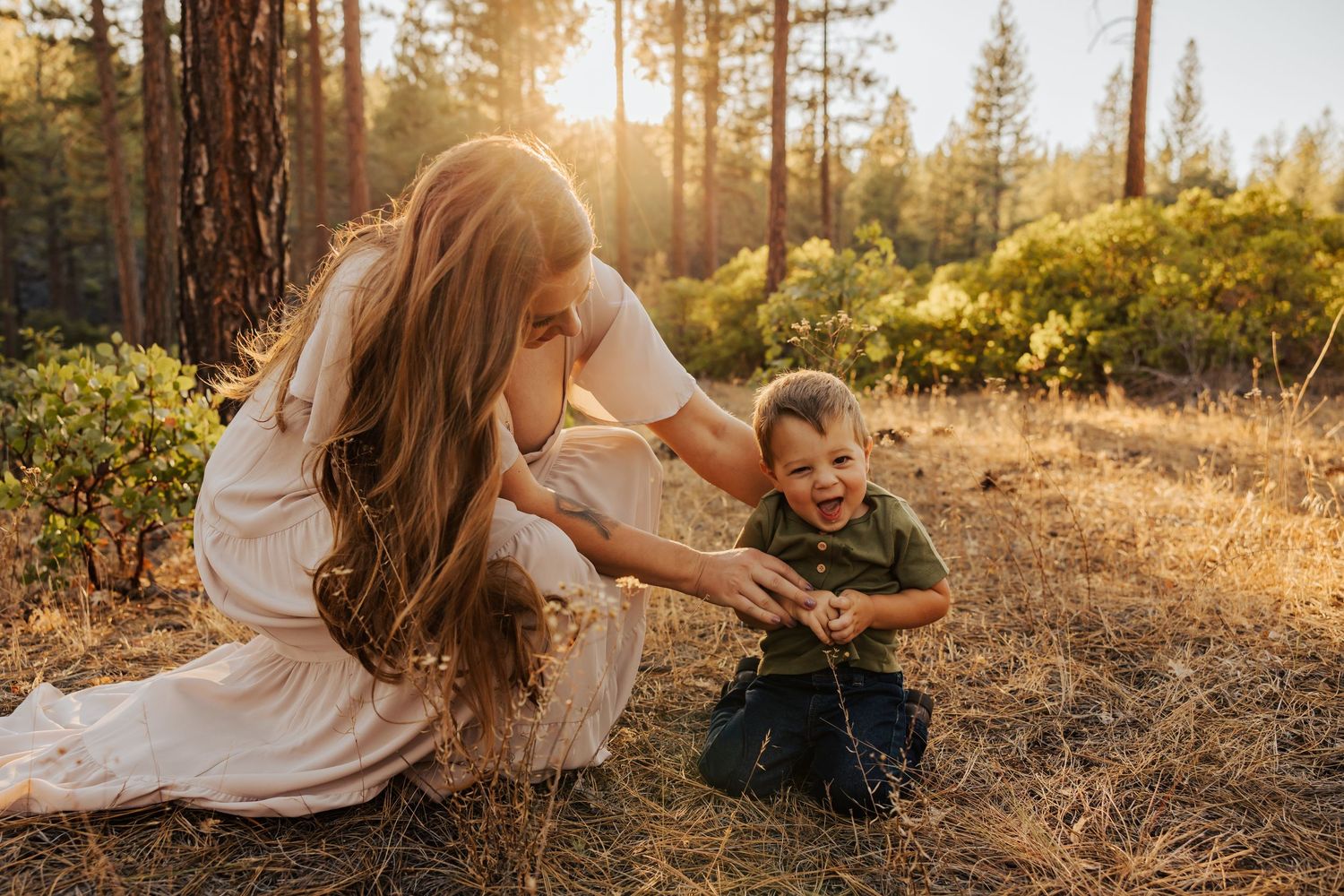 Natural lifestyle family photography session in golden forest setting.