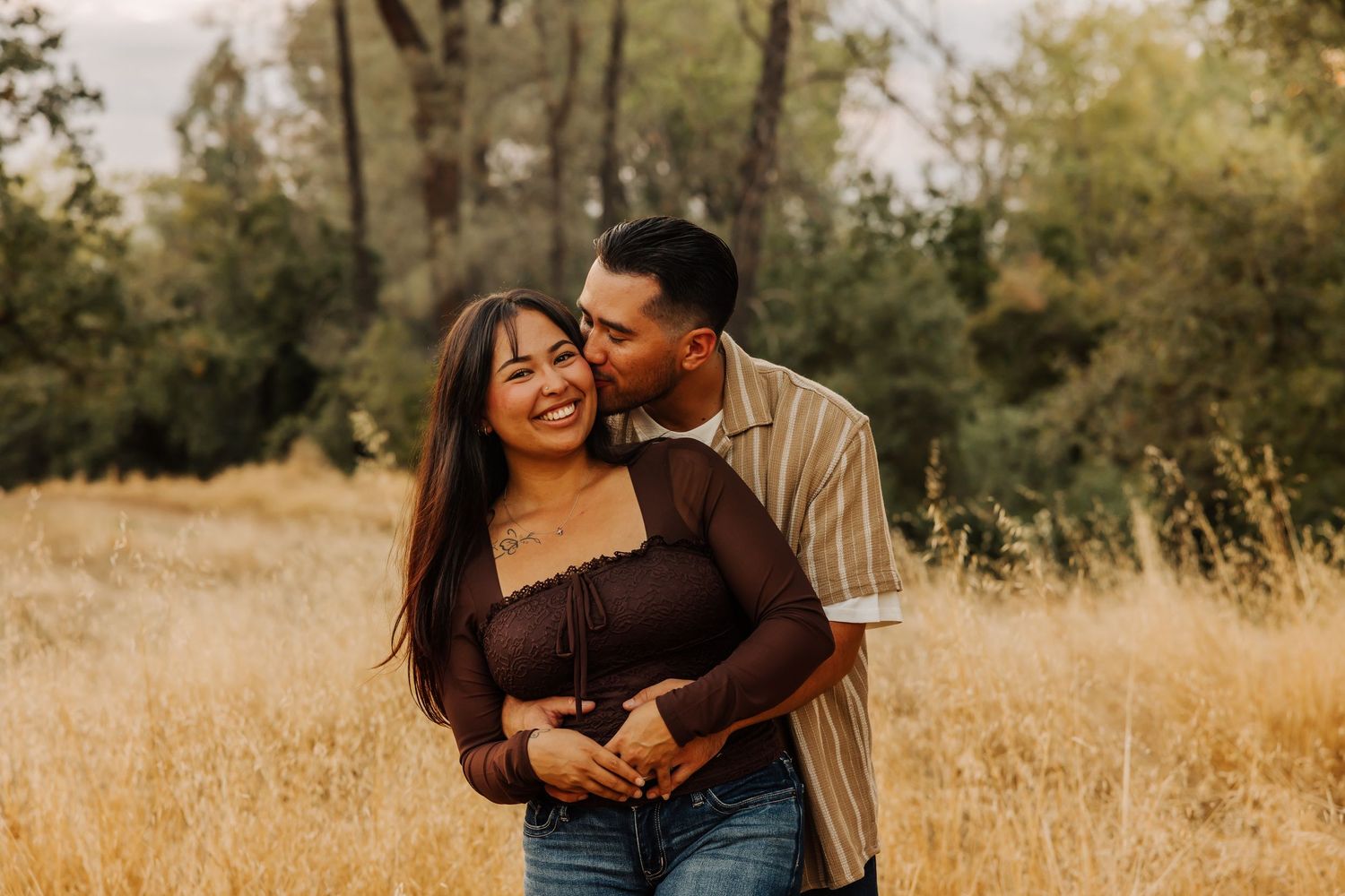 Candid family moments captured in a rustic outdoor setting with natural lighting.