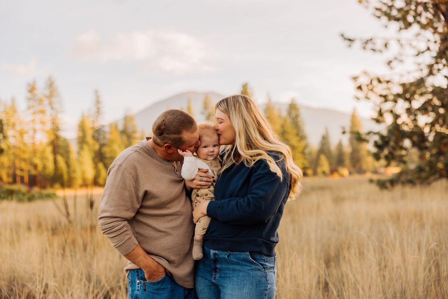 Candid family moments captured in a field during golden hour.