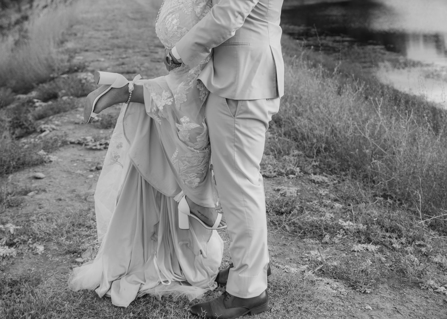 A black and white photo capturing a couple's intimate dance moment at their wedding.