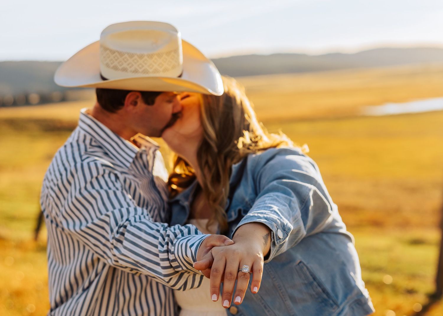 An intimate moment captured during a countryside engagement photoshoot at sunset.