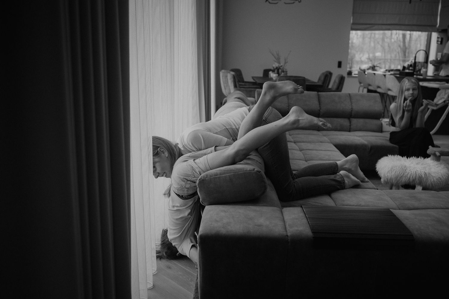 Black and white sequence showing lounging positions on a gray couch.