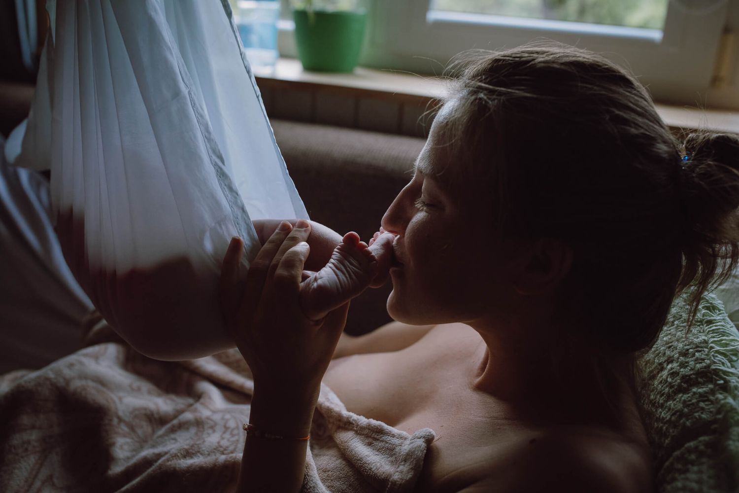 Moody indoor portrait series showing quiet moments between parent and child.