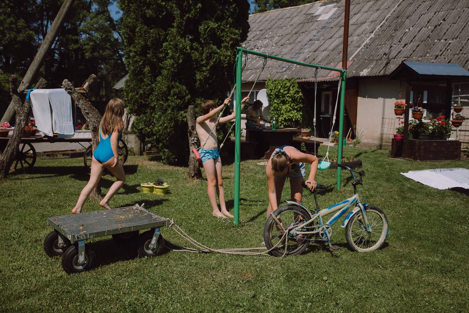 Group exercising outdoors near playground equipment and a bicycle on a sunny day.