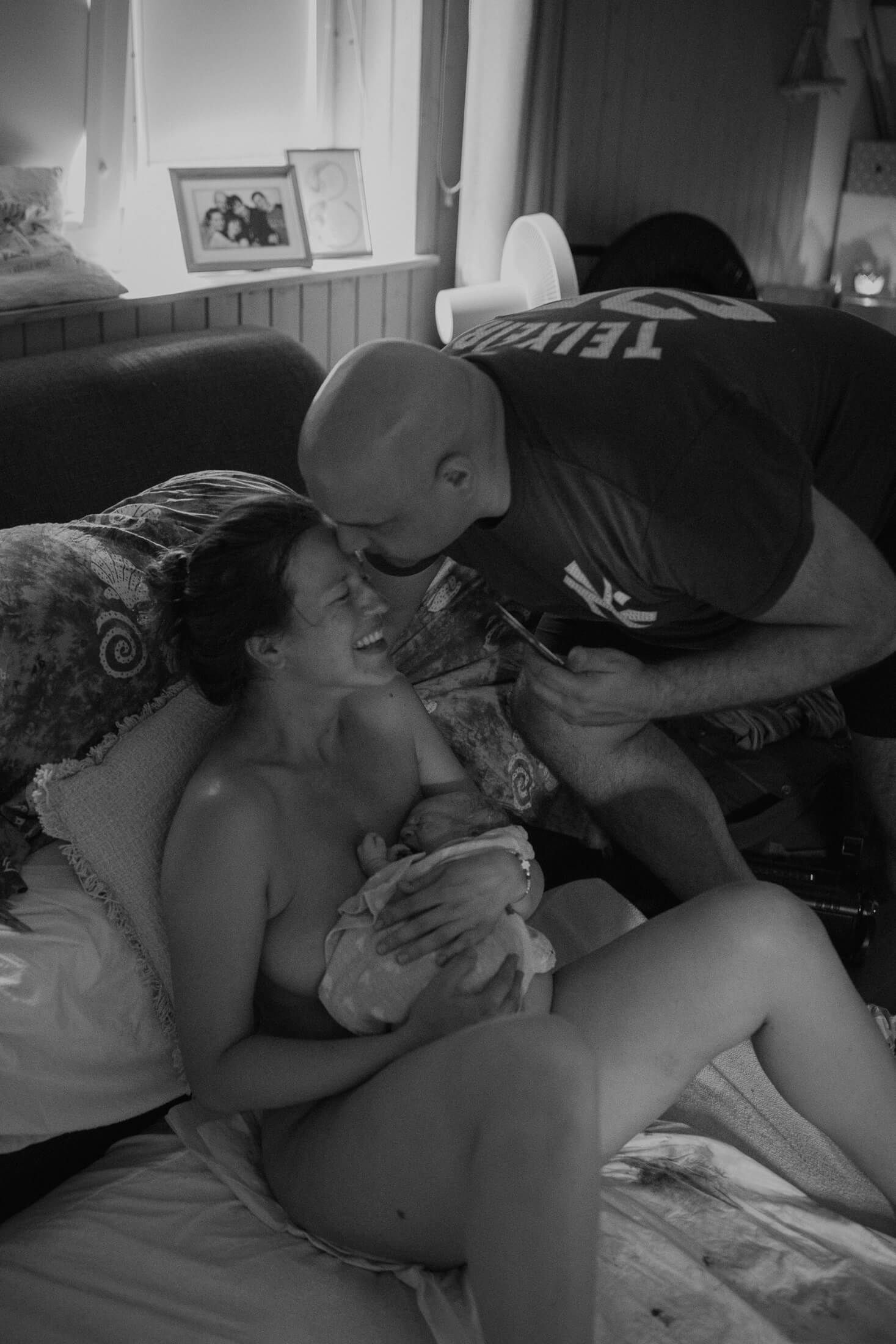 Candid black and white photo showing emotional support during labor.