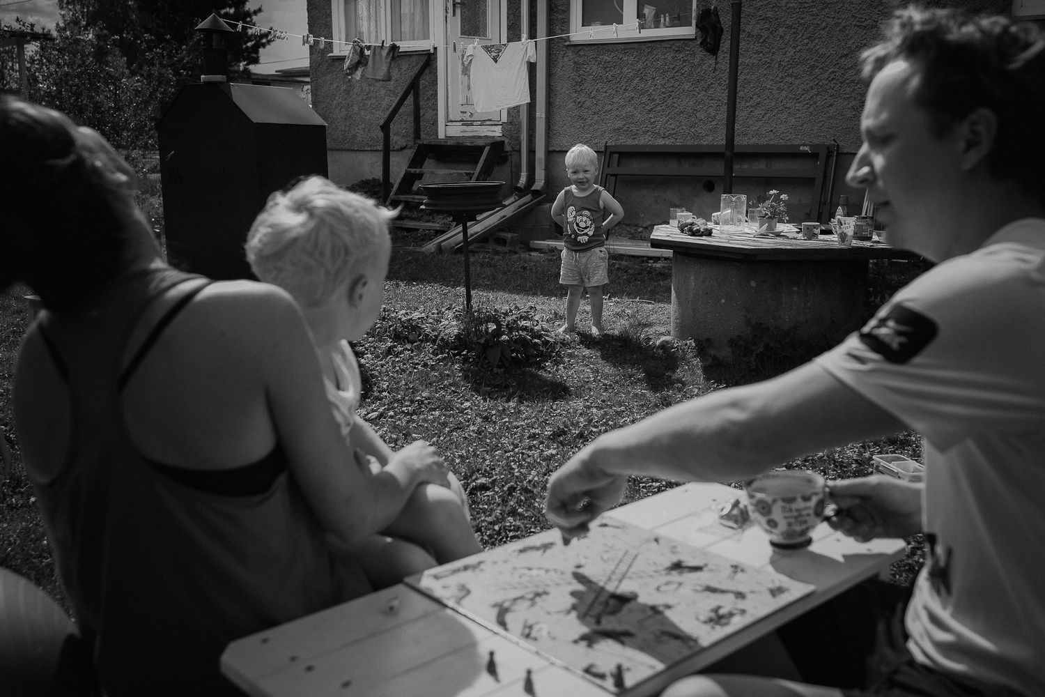 People gathered around a table for a casual outdoor meal or activity.