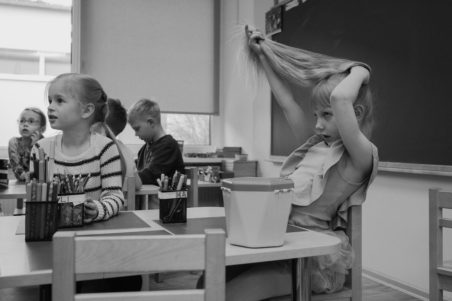 Students in a science classroom conduct experiments and observations using microscopes and lab equipment.