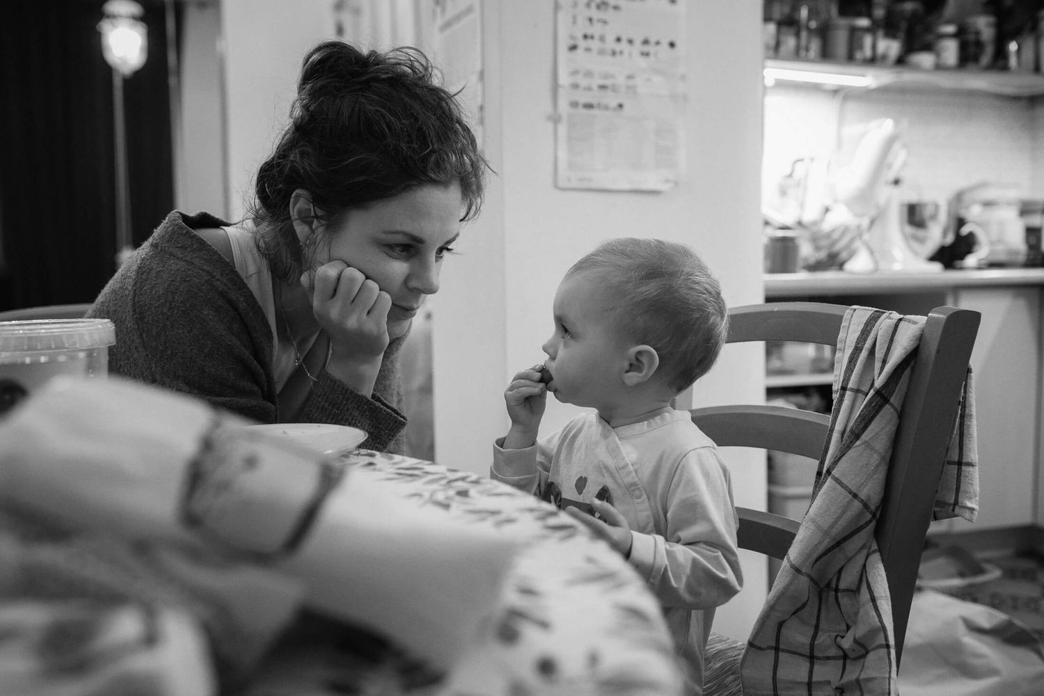 Black and white candid moments captured in a home setting.