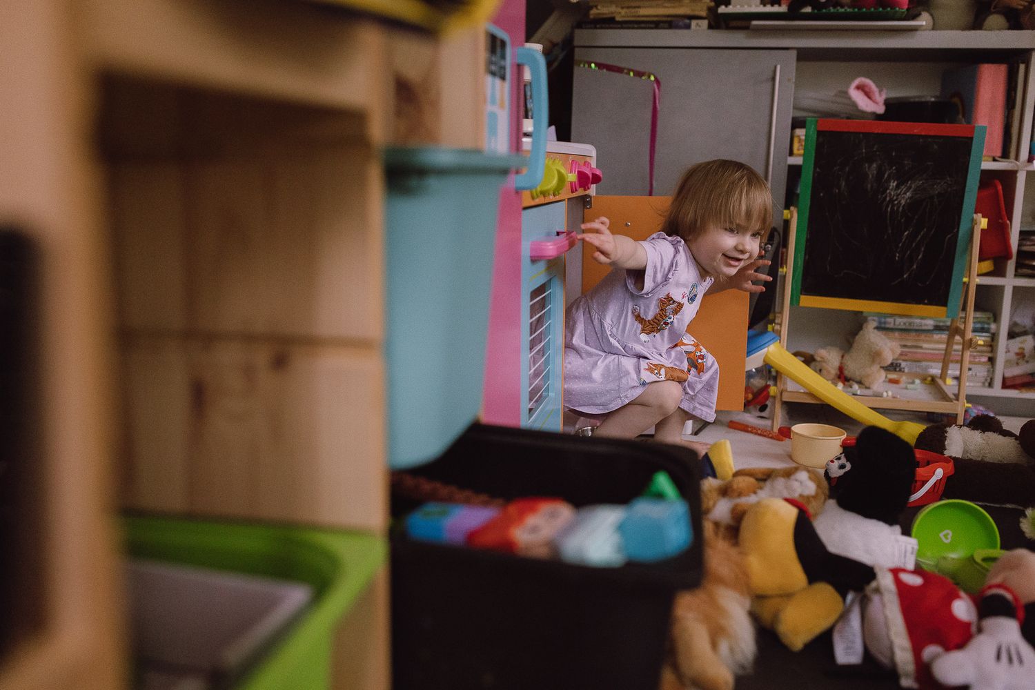 Cluttered shelf filled with colorful toys and stuffed animals.