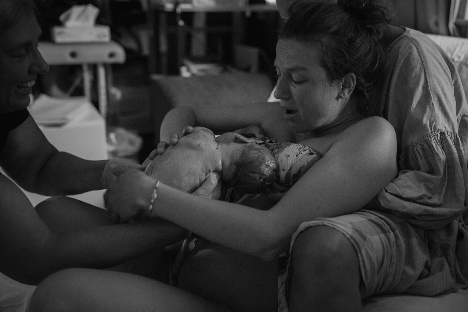 Emotional black and white image capturing a tender moment during labor.