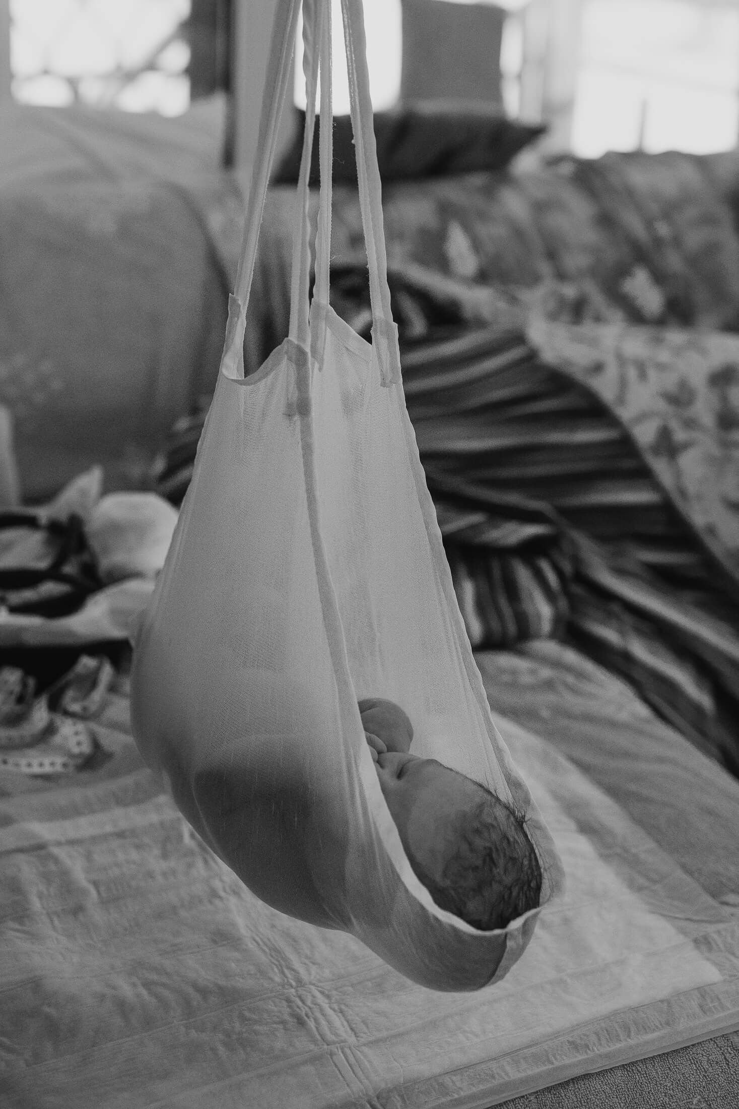 Medical equipment and supplies arranged on a hospital bed in black and white.
