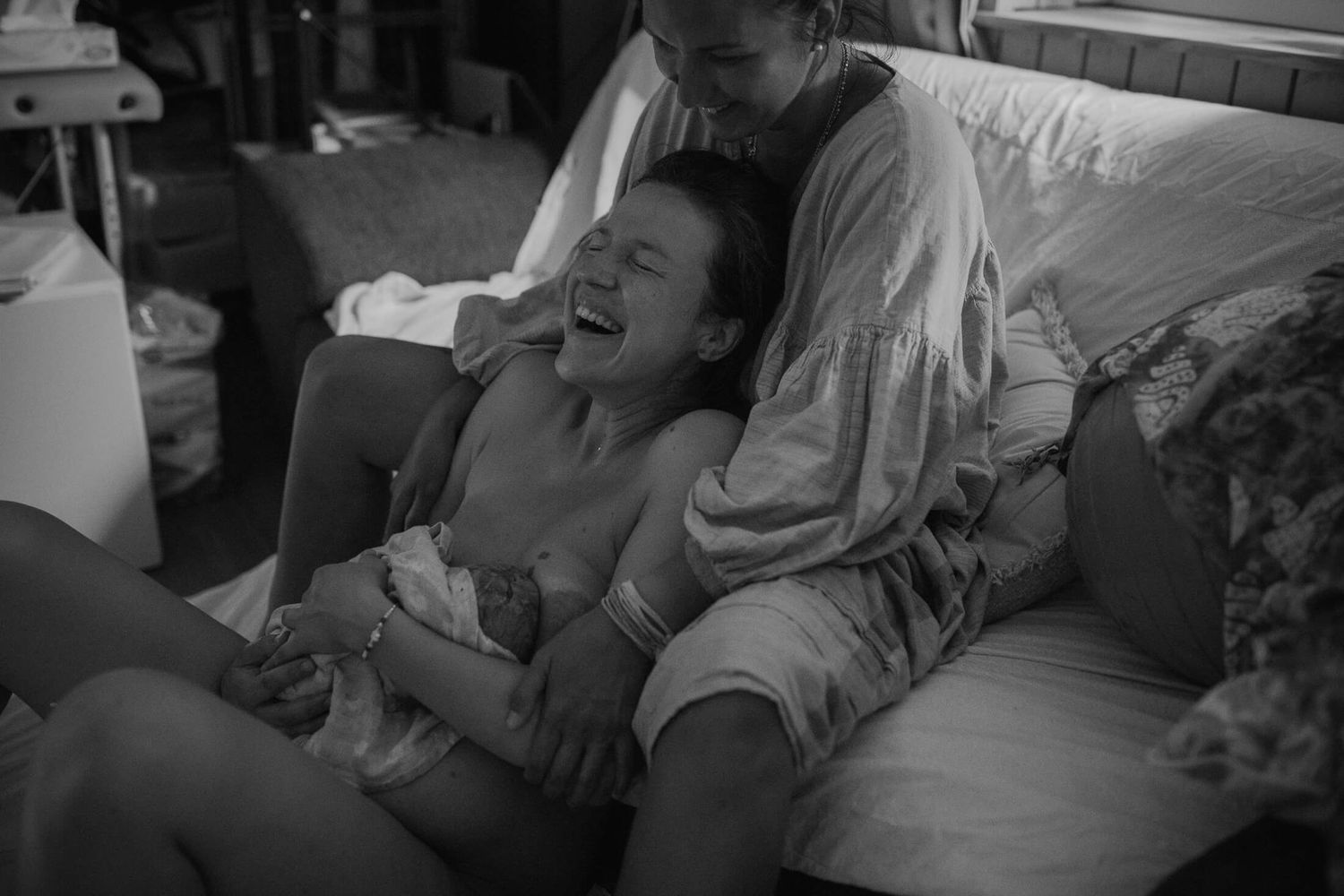 Atmospheric black and white photograph documenting a natural birth experience.