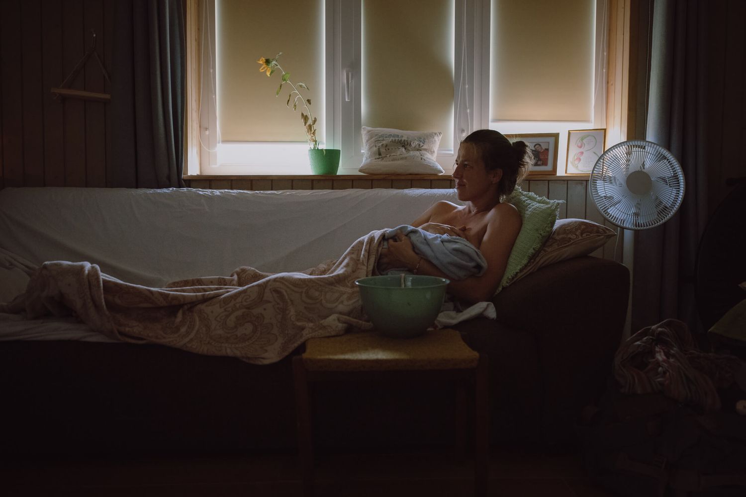 Sunlit room with medical equipment visible through window during birth preparation.
