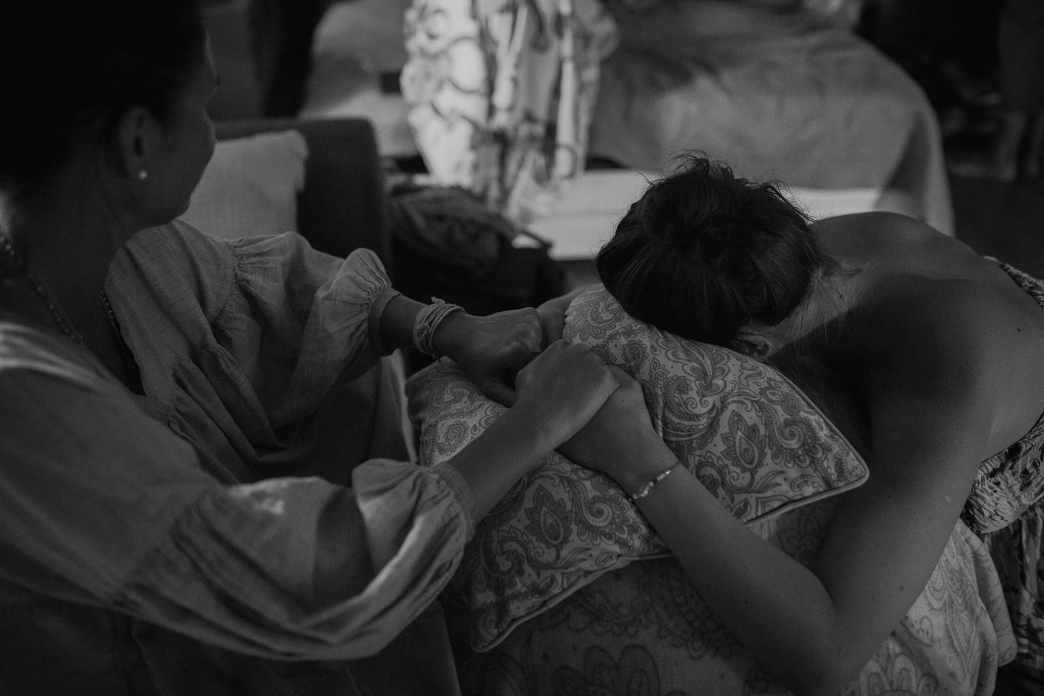 Black and white photo of a person lying in bed during a home birth experience.