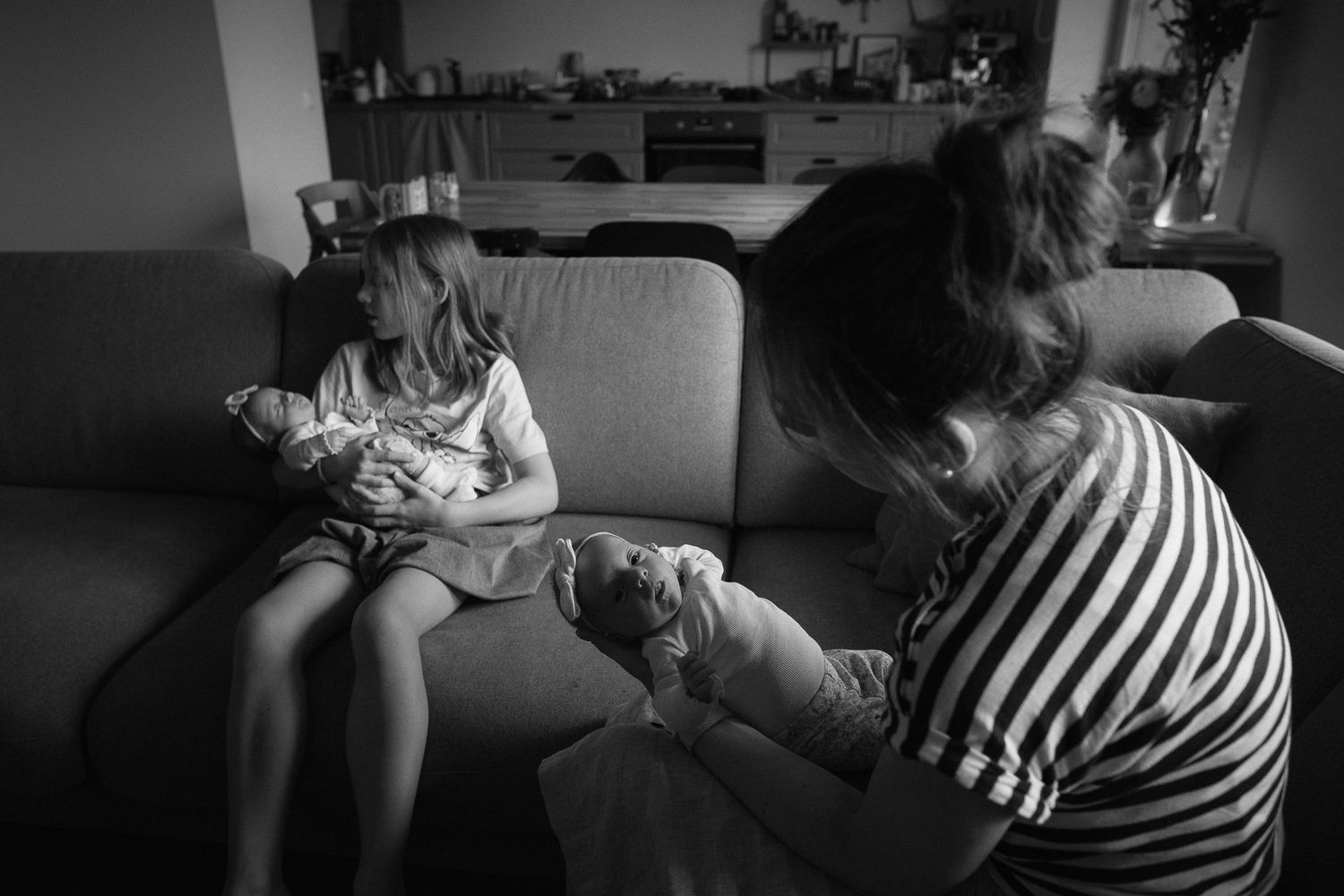 Intimate black and white photographs showing tender moments in a domestic setting.