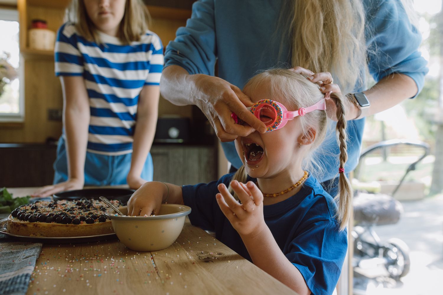 Family enjoying homemade baked goods around a wooden kitchen table.