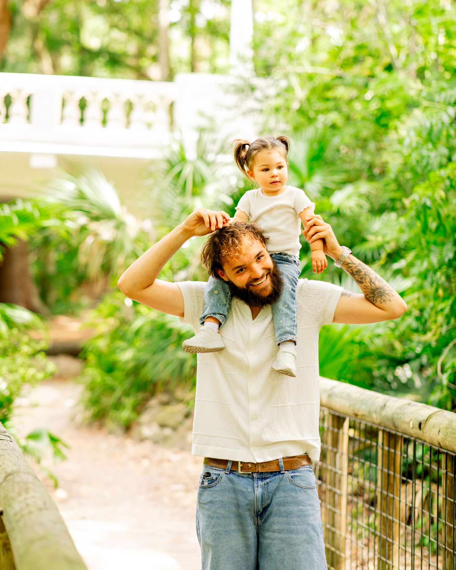 Dad holding his baby girl on his shoulder during a Father's Day mini session in Orlando, FL