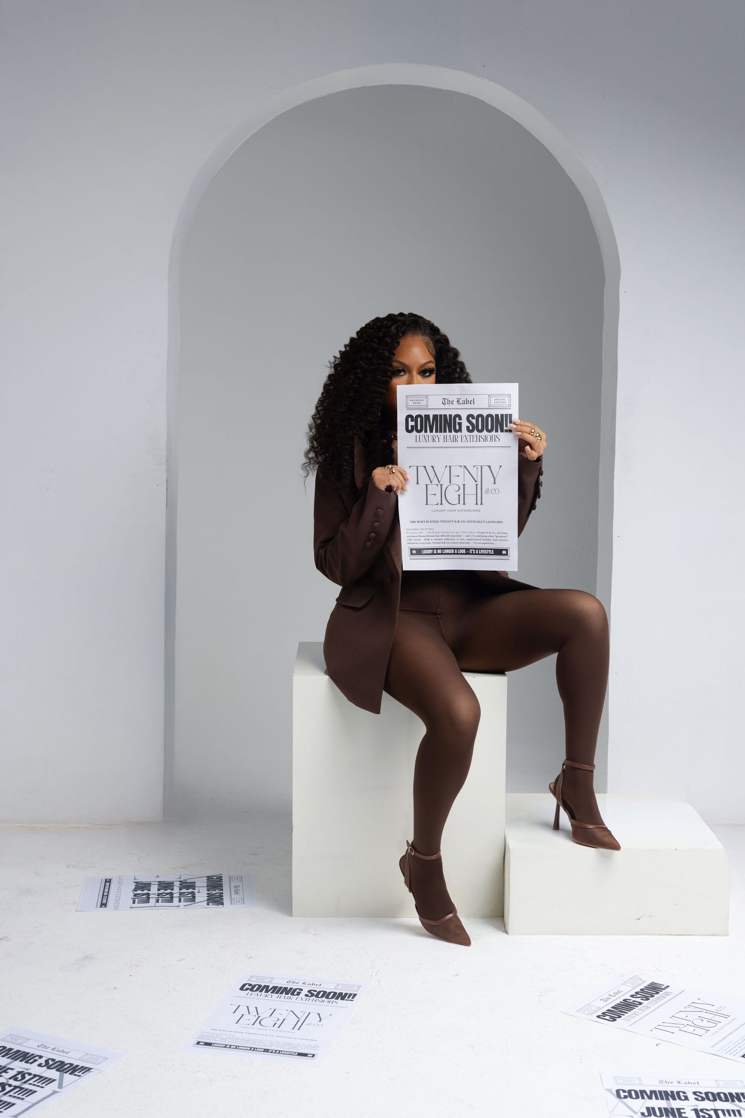 Minimalist white studio shoot with arched doorway and text cards.