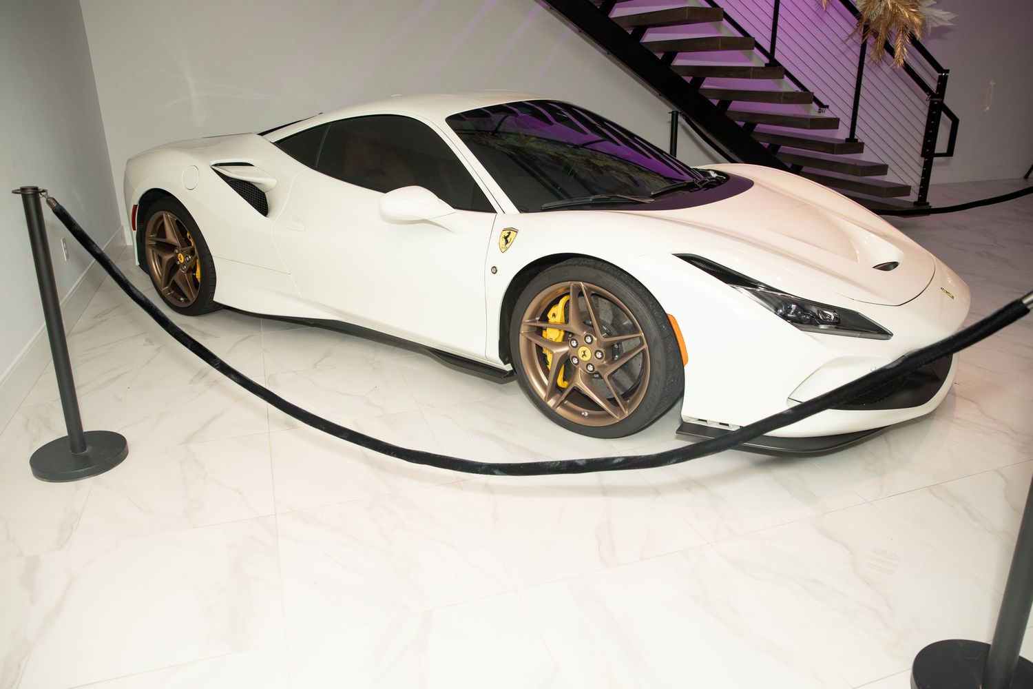 White and black sports car photographed from multiple angles showing sleek modern design and aerodynamic features.