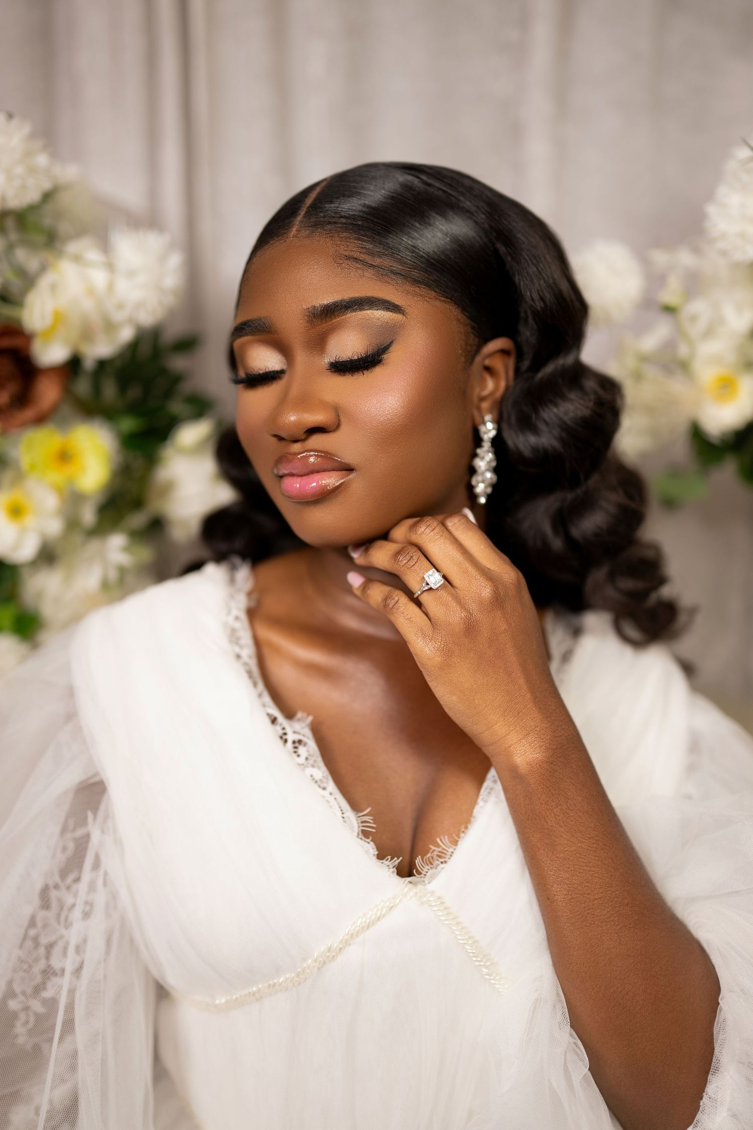 Elegant bridal beauty portrait with glamorous makeup and statement earrings.