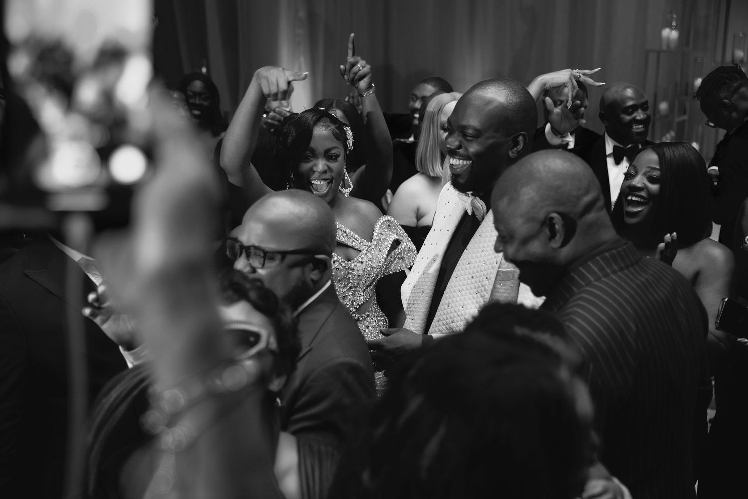 Black and white photo of a joyous crowd celebrating at what appears to be a party or celebration event.