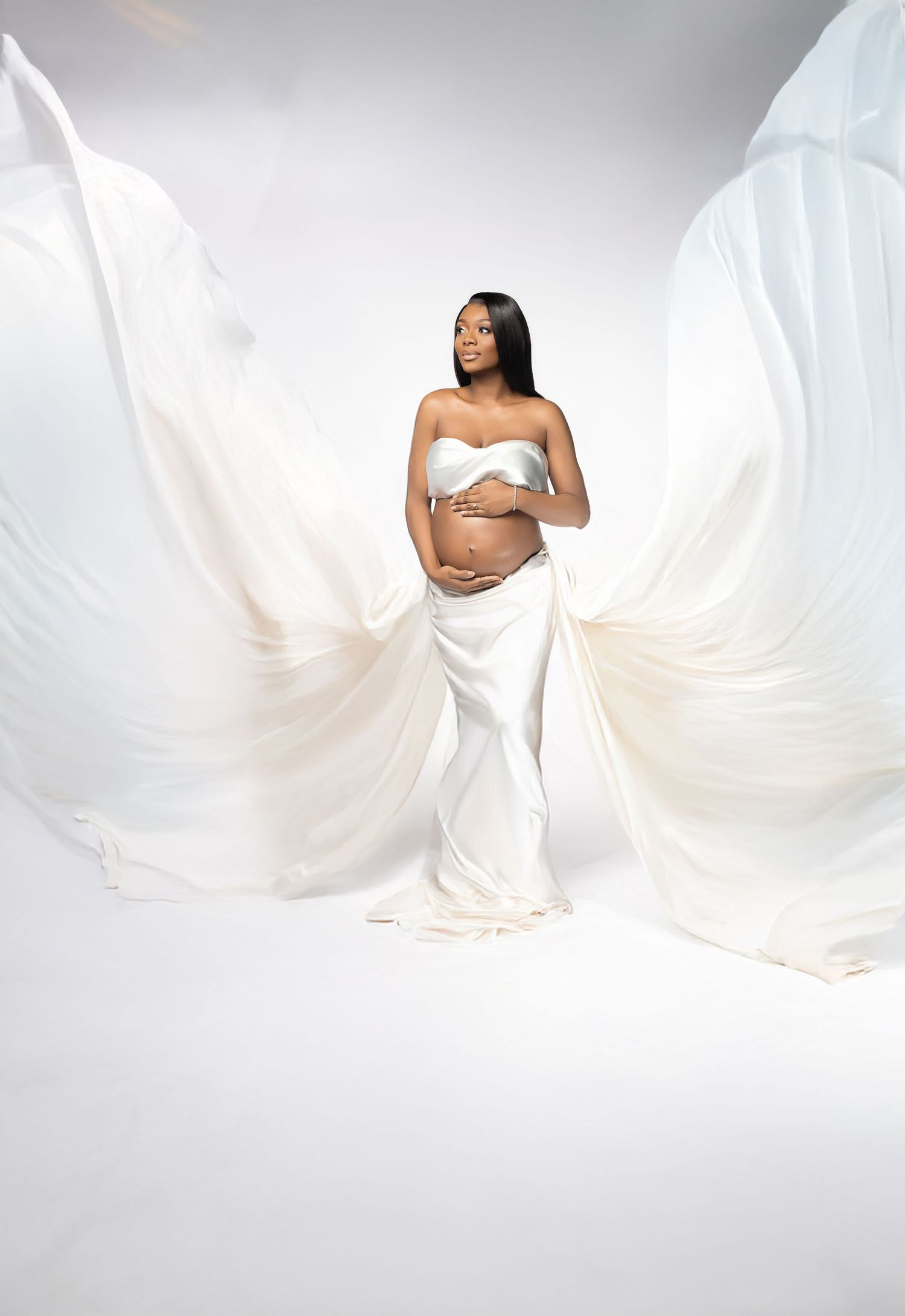 A series of ethereal maternity photos featuring white flowing fabric against a bright white background.