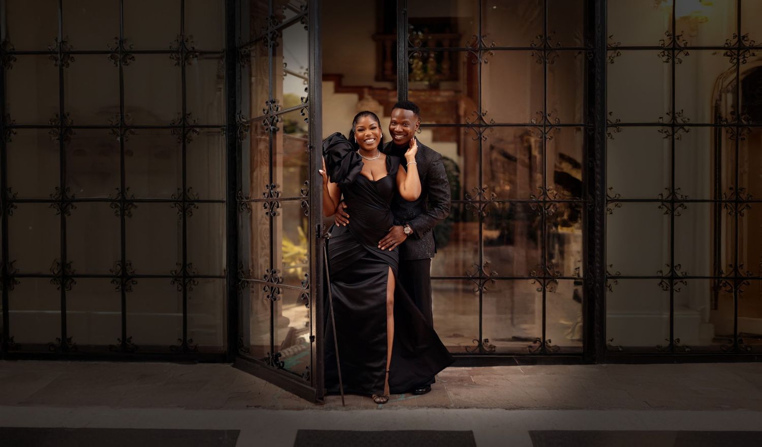 A couple dances passionately in an intimate embrace on a dimly lit stage during a theatrical performance.