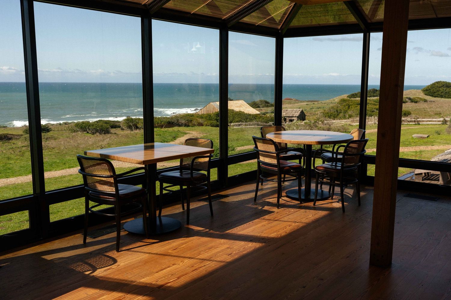 The Solarium offers panoramic views of the Pacific Ocean through large windows.