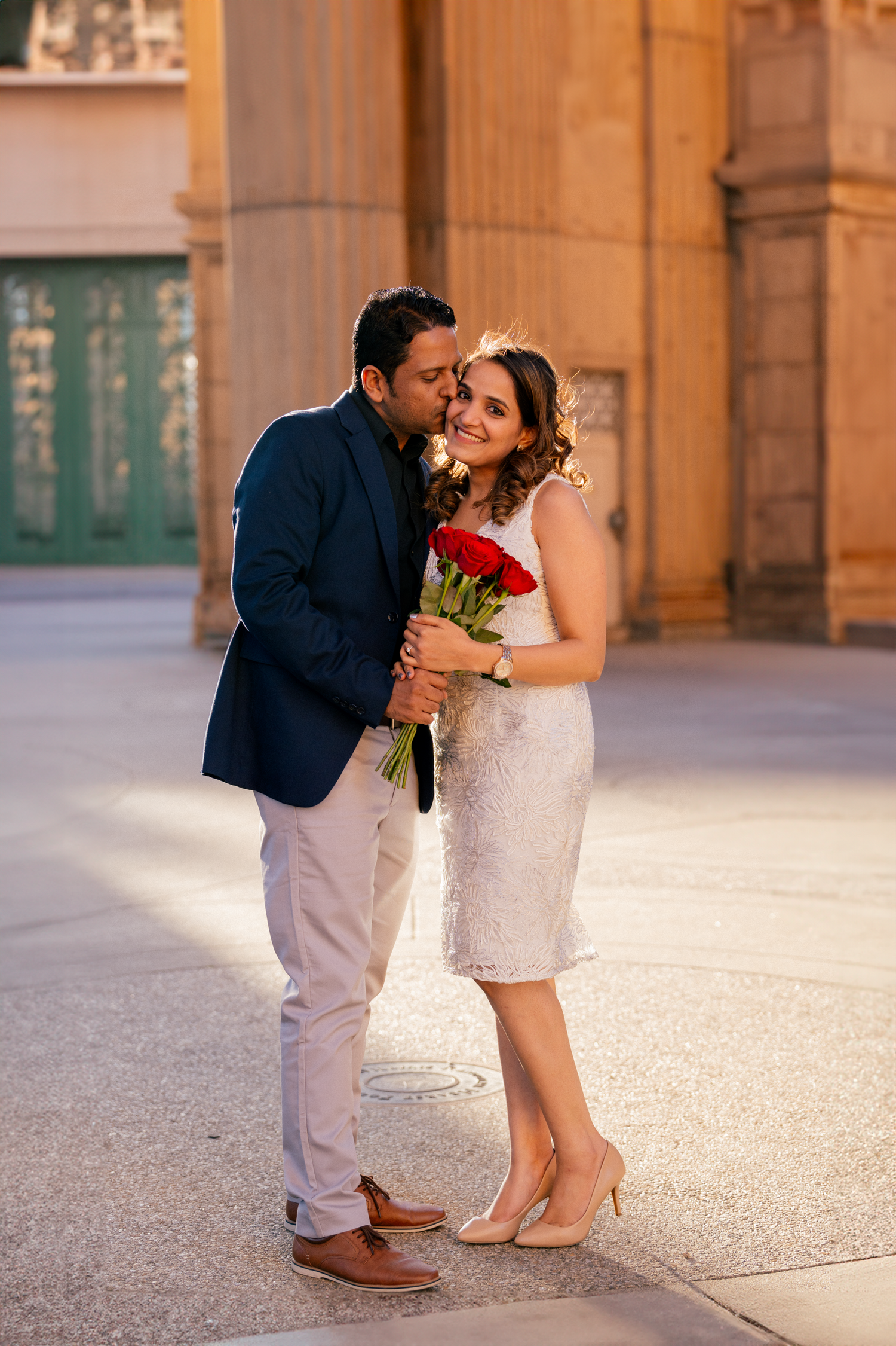 A romantic moment captured at the Palace of Fine Arts with roses.