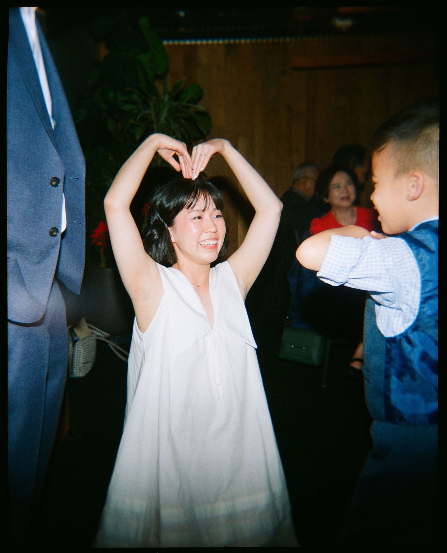 Bride making a heart with her hands around her head.