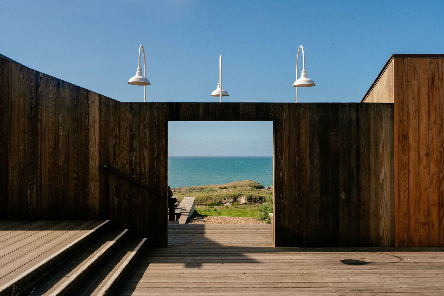 Modern wooden deck with portal framing the Pacific Ocean at the Sea Ranch Lodge.