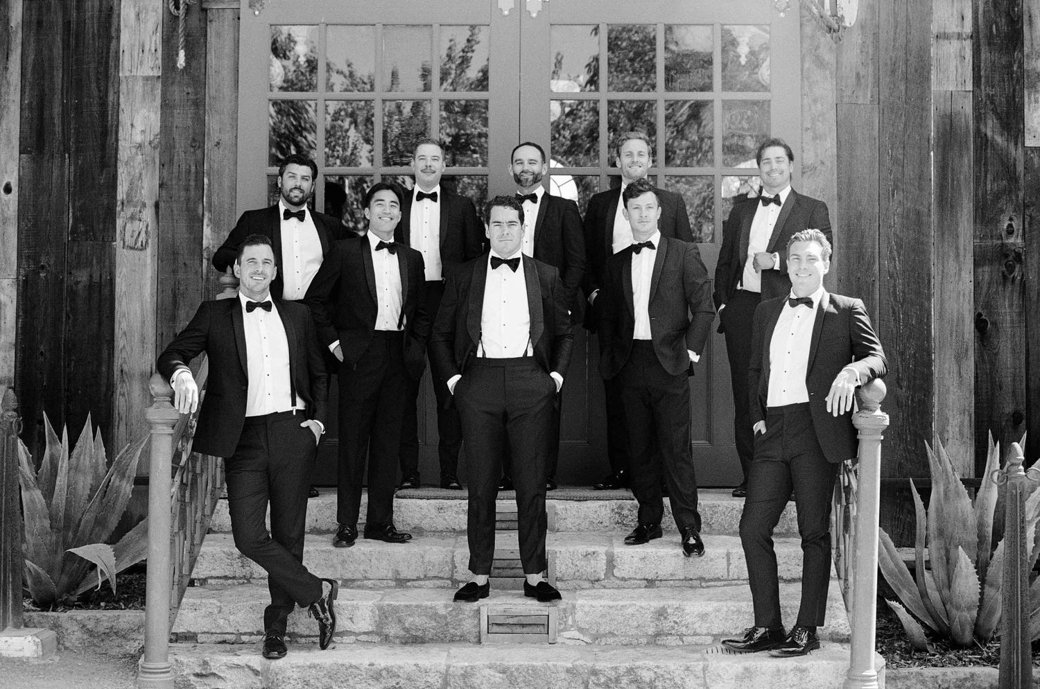 Groomsmen standing on stairs together.
