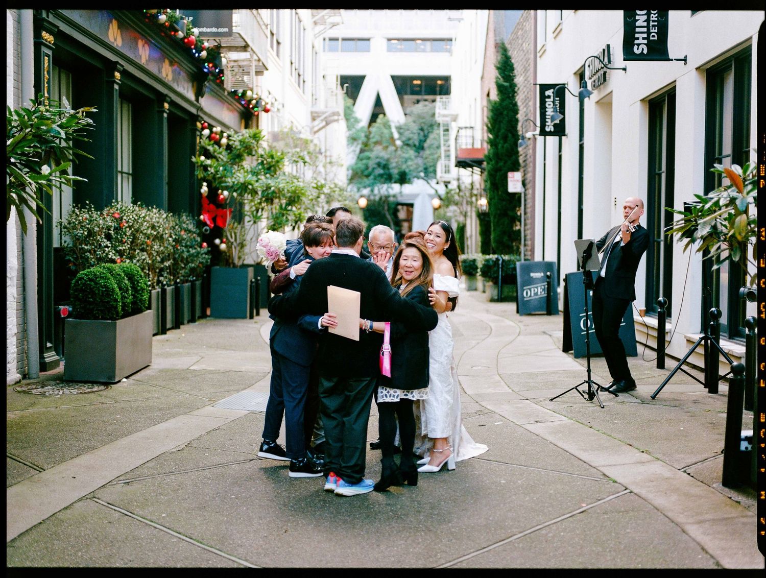 A series of street scenes showing people walking on sidewalks and browsing through urban shopping districts in a city.